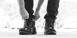 man pulling on boots