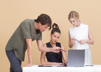 gathered around a laptop